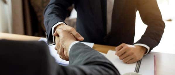 Car Salesman And Customer Shaking Hands