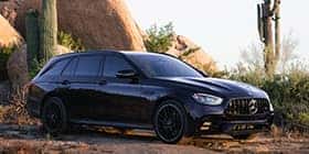 Black Mercedes-Benz E-class car parked in a rocky desert landscape in Gilbert, AZ