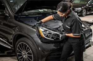 A technician performing service on a Mercedes-Benz vehicle