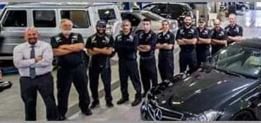 group of mechanics in service bay