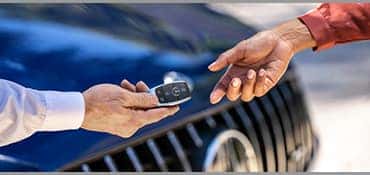 person handing keys to another