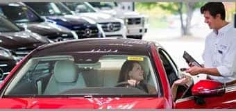 woman in car talking to service tech