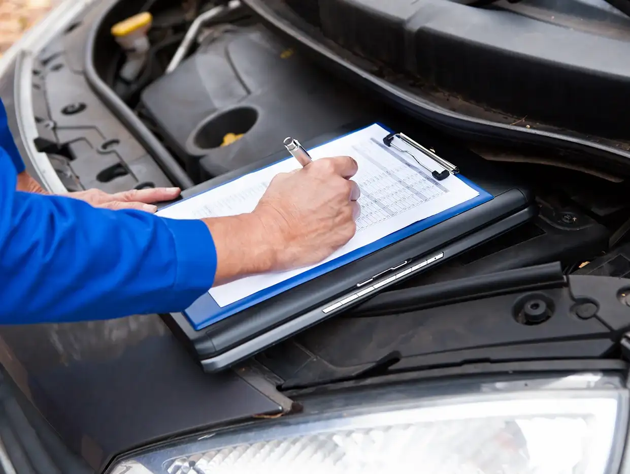 Service tech looking at a car.