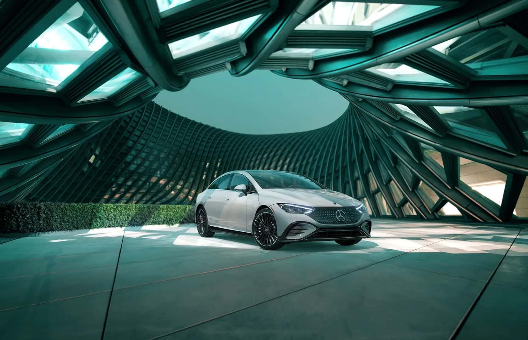 2026 Mercedes-AMG EQE Sedan driving aggressively on a winding road