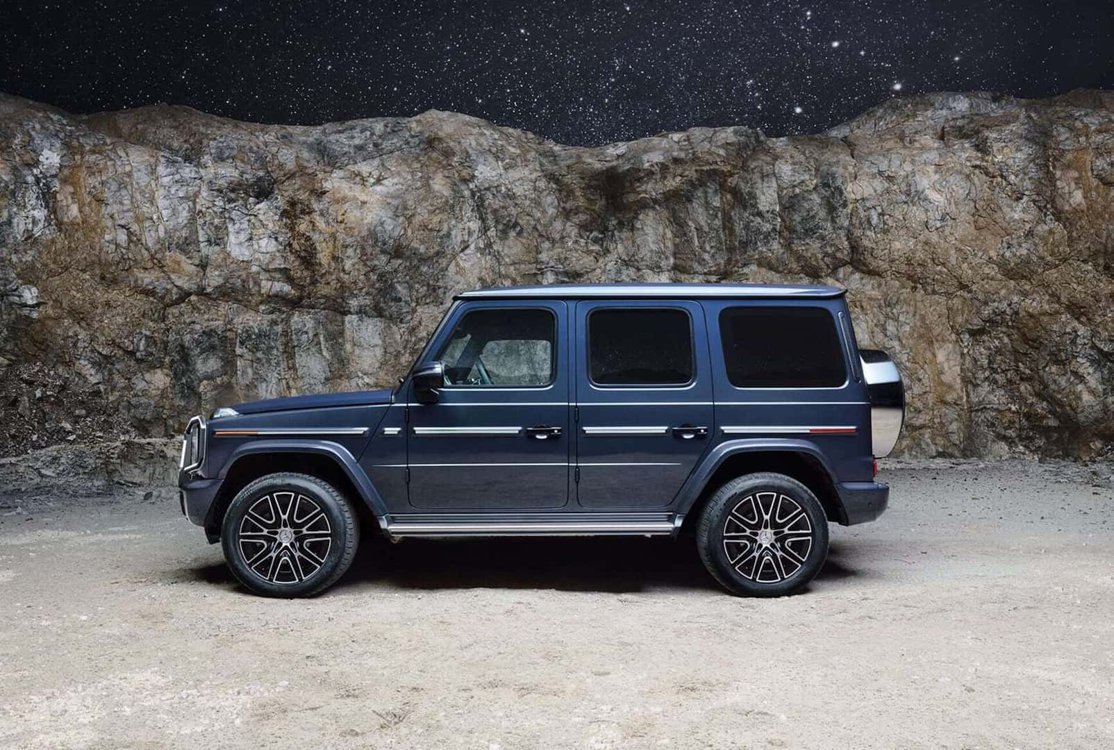 2026 Mercedes-Benz G-Class Suv sitting parked in front of a rock formation.