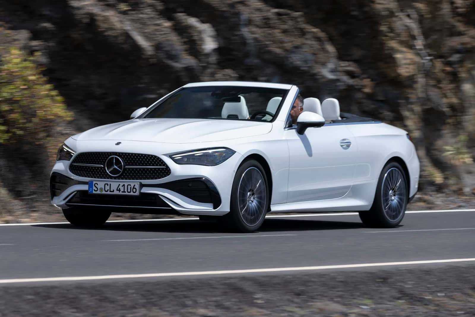 2026 Mercedes-Benz CLE Cabriolet driving on a scenic highway.