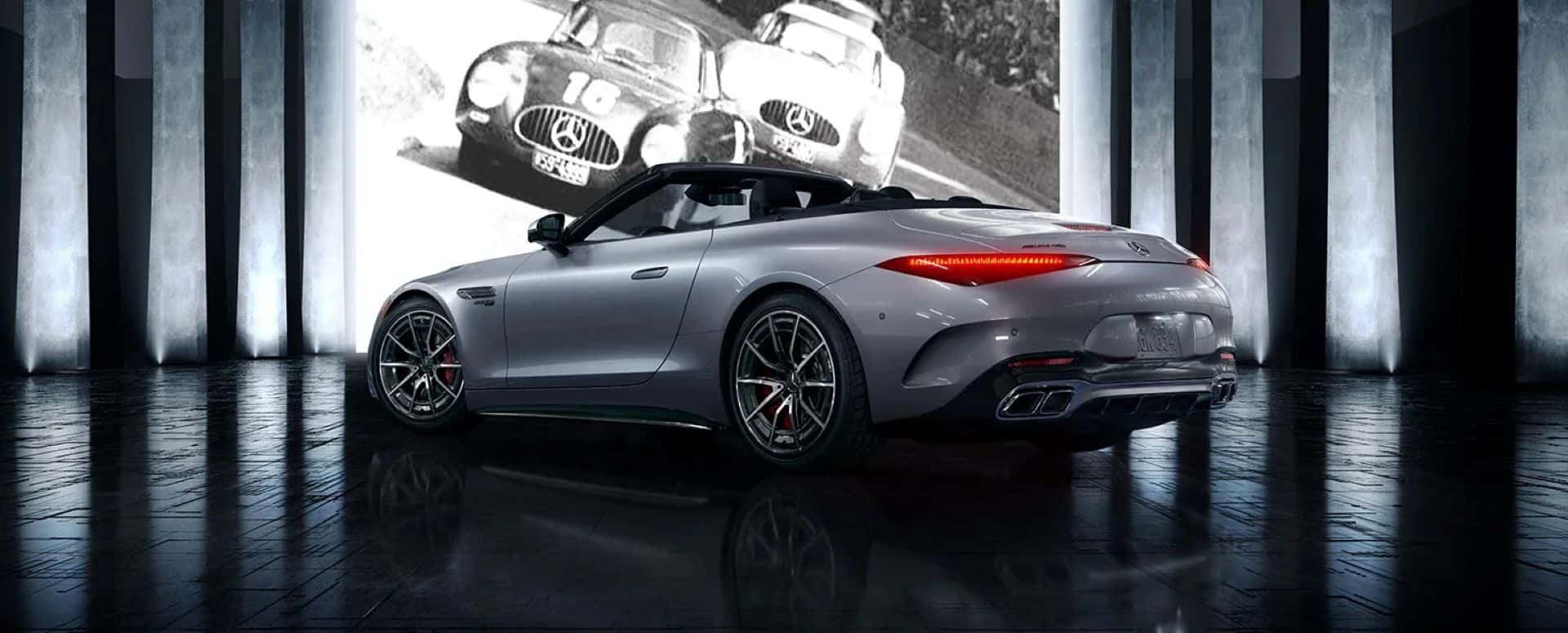 A silver Mercedes-Benz AMG SL ROADSTER sitting parked indoors.