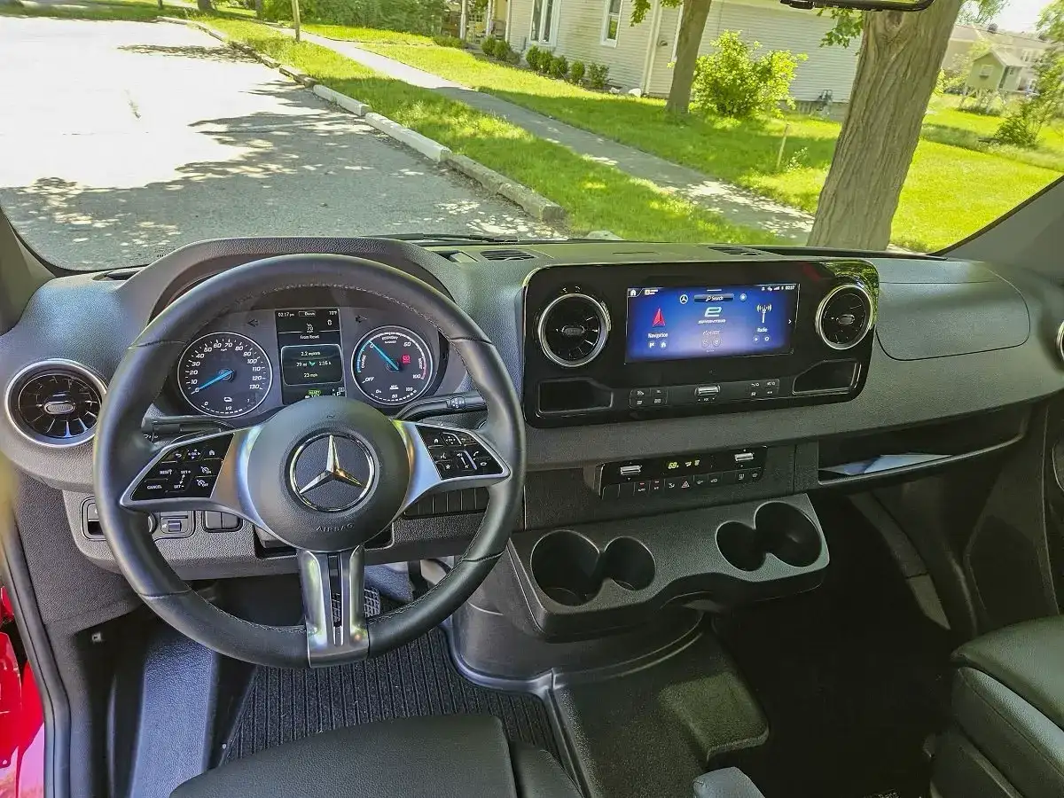 Interior view of the front media console and steering wheel of the Mercedes Benz eSprinter
