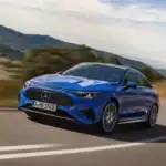 2026 blue Mercedes Benz CLA driving around a bend