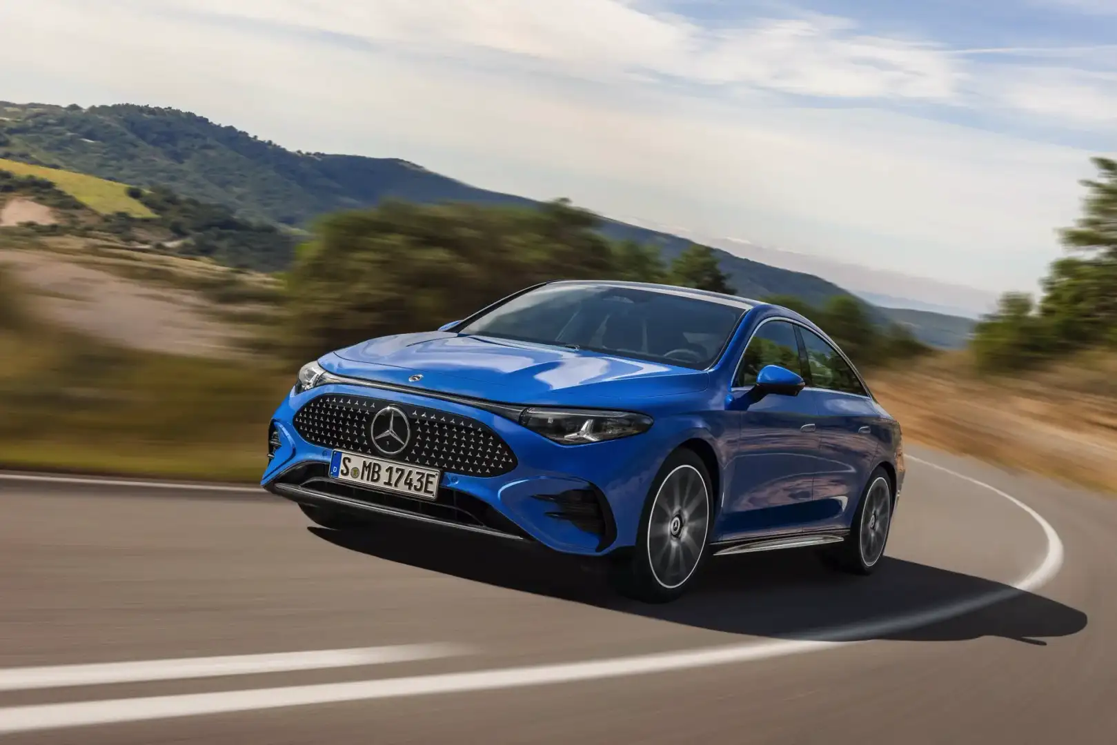 2026 blue Mercedes Benz CLA driving around a bend