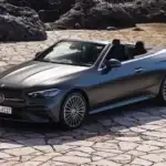 Mercedes-Benz CLE Cabriolet view of the front with the top down parked on a cobble stone driveway