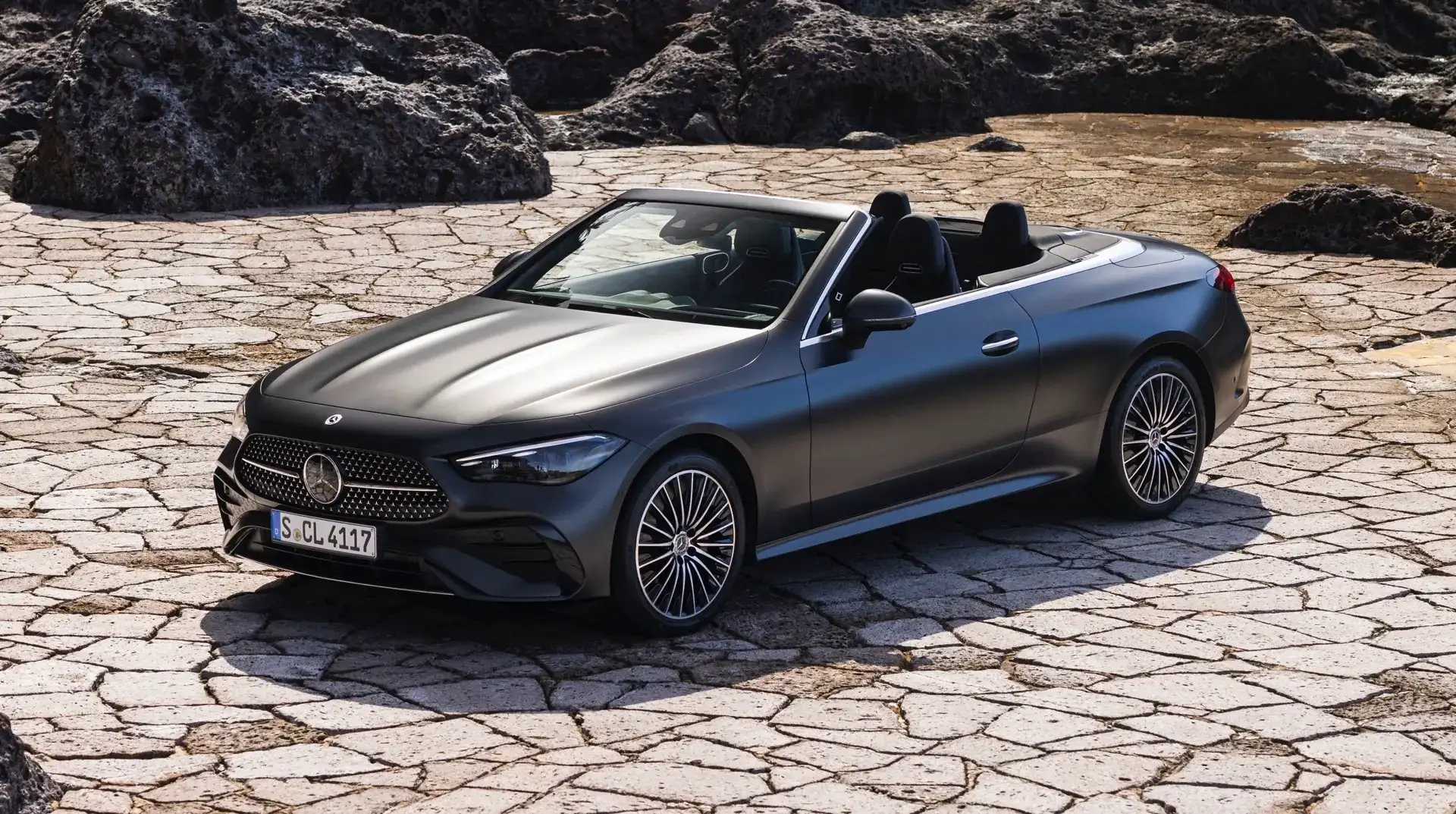 Mercedes-Benz CLE Cabriolet view of the front with the top down parked on a cobble stone driveway