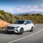 White Mercedes-Benz GLC 300 view of the front driving on a winding mountain road