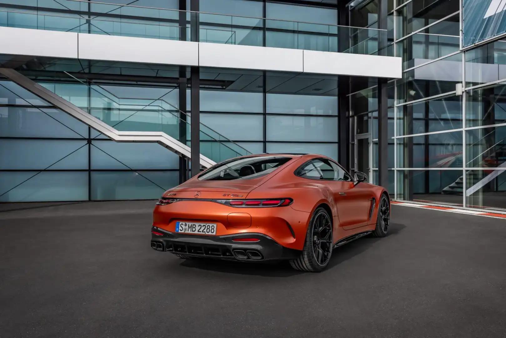 Orange Mercedes-AMG GT 63 S E Performance view of the rear parked in front of a building