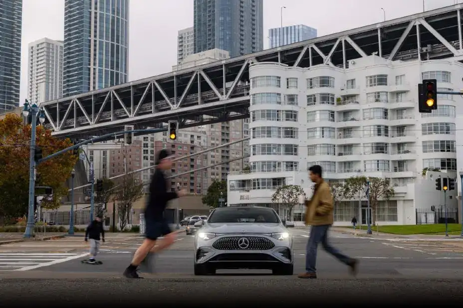 2026 Mercedes-Benz CLA stopping on its own with pedestrians walking across the street