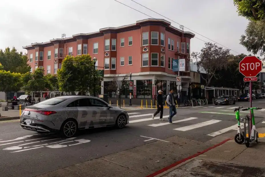 2026 Mercedes-Benz CLA stopped on a city street waiting for pedestrians to cross
