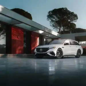 2026 Mercedes Benz E Class Wagon AMG E 53 Hybrid White parked next to building