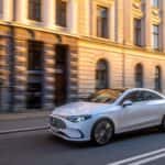 The Luxurious And Fashionable Mercedes Benz CLA EV Driving Past European-Esque Office Buildings