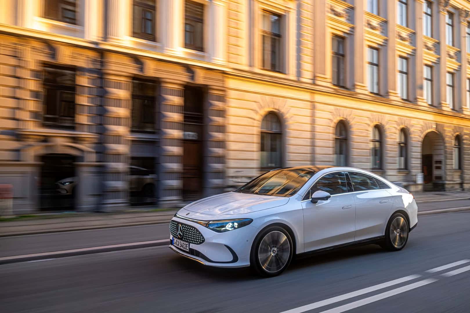 The Luxurious And Fashionable Mercedes Benz CLA EV Driving Past European-Esque Office Buildings