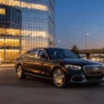 2026 Mercedes-Benz S-Class sedan parked at Plano corporate campus along Dallas North Tollway at dusk