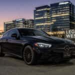 2026 Mercedes-Benz CLE Coupe on the Dallas North Tollway near Legacy West at dusk