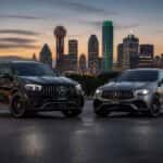 2026 Mercedes-AMG GLC and 2026 Mercedes-AMG GLE side by side on a Dallas-area boulevard at dusk