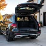 2026 Mercedes-Benz GLE with open liftgate revealing spacious cargo area, parked in a Plano Texas suburban driveway on a sunny autumn morning