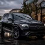 2026 Mercedes-Benz GLE on a wet road in Plano TX with rain-sensing wipers active during a spring storm