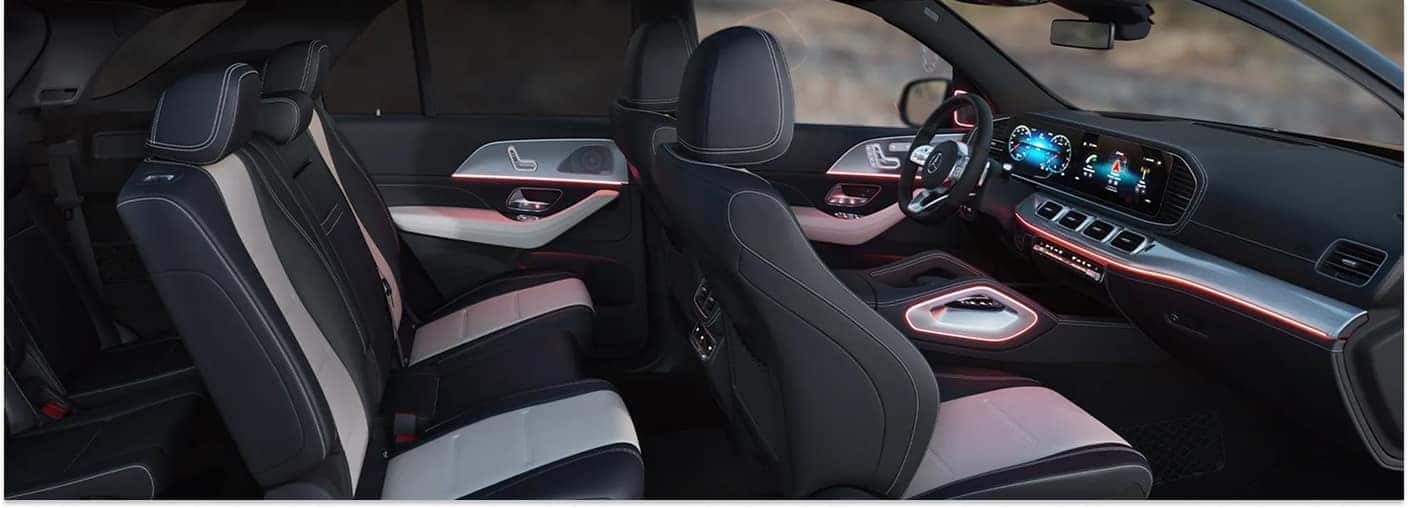 Interior view of the 2026 Mercedes-Benz GLE SUV featuring two-tone leather seats and red ambient dashboard lighting.