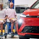 The Human-Like Crash Test Dummies Placed Beside The Sexy Red Chevrolet Bolt