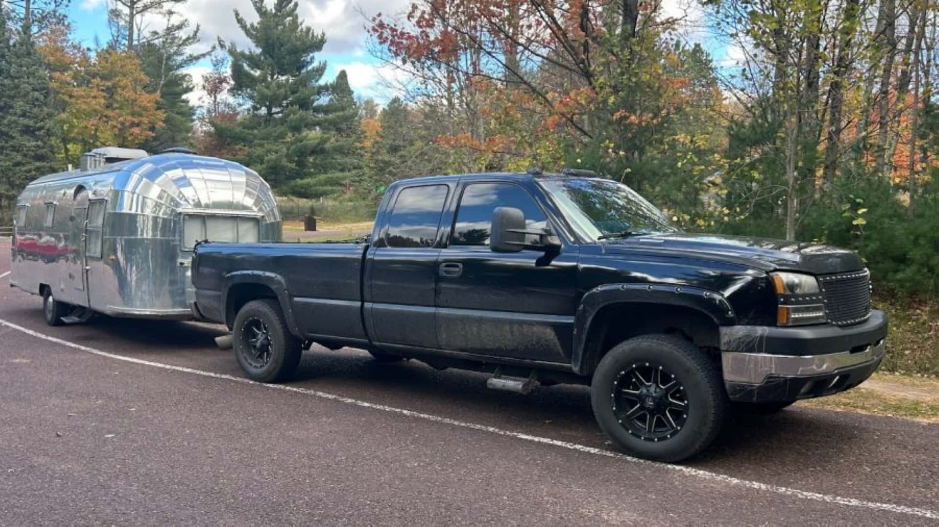 Muncy's Persevering Silverado With A Metallic Camper Hitched At Its End