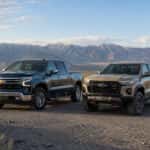 2026 Chevrolet Silverado 1500 and 2026 Chevrolet Colorado side by side on a high-desert Nevada gravel road