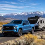 2026 Chevrolet Silverado 1500 towing a travel trailer near Washoe Lake State Park with the Sierra Nevada in the background