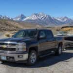 Used Chevrolet Silverado 1500 with boat trailer on a Nevada highway near the Sierra Nevada mountains outside Carson City