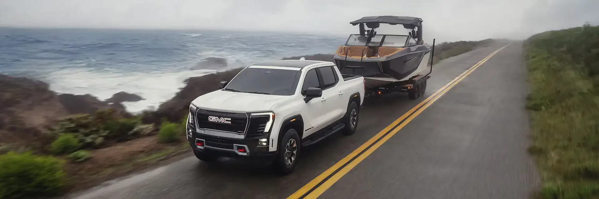 2026 GMC Sierra EV Towing a Boat