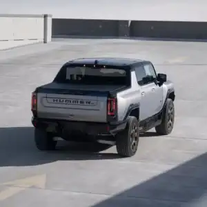 2026 GMC HUMMER EV Pickup Meteorite Metallic driving on ramp