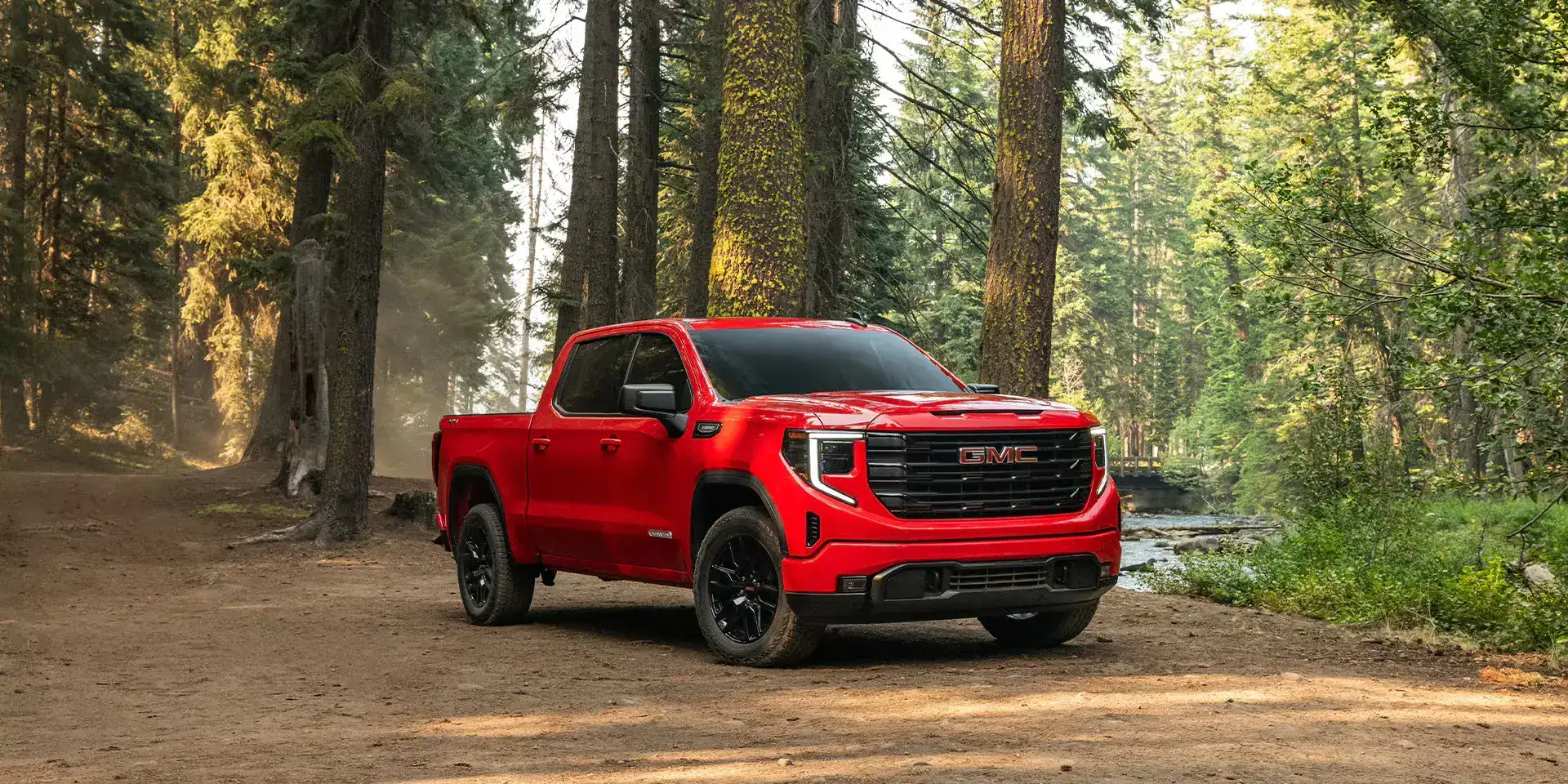 2026 GMC Sierra 1500 Cardinal Red in the woods