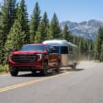 2026 GMC Sierra 1500 towing a travel trailer on US-50 near Spooner Summit in the Carson Range, Nevada