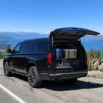 2026 GMC Yukon XL with liftgate open at Spooner Summit on US-50, packed for a Lake Tahoe weekend trip