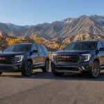2026 GMC Terrain and 2026 GMC Acadia side by side on a Nevada high-desert road near the Carson Range
