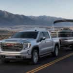 2026 GMC Sierra 1500 towing a pontoon boat through Washoe Valley, Nevada with the Carson Range in the background