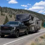 2026 GMC Sierra 2500 HD towing a fifth-wheel trailer on US-50 through Northern Nevada high desert near Spooner Summit