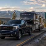 2026 GMC Sierra 2500 HD towing a fifth-wheel trailer on US-50 toward Spooner Summit in the Carson Range, Nevada