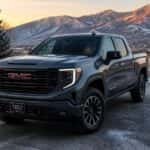 2026 GMC Sierra 1500 parked at dawn in Carson City with TPMS warning light visible through windshield and frost on the driveway