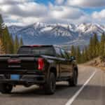2026 GMC Sierra 1500 climbing US-50 toward Spooner Summit in early October with snow on the ridge