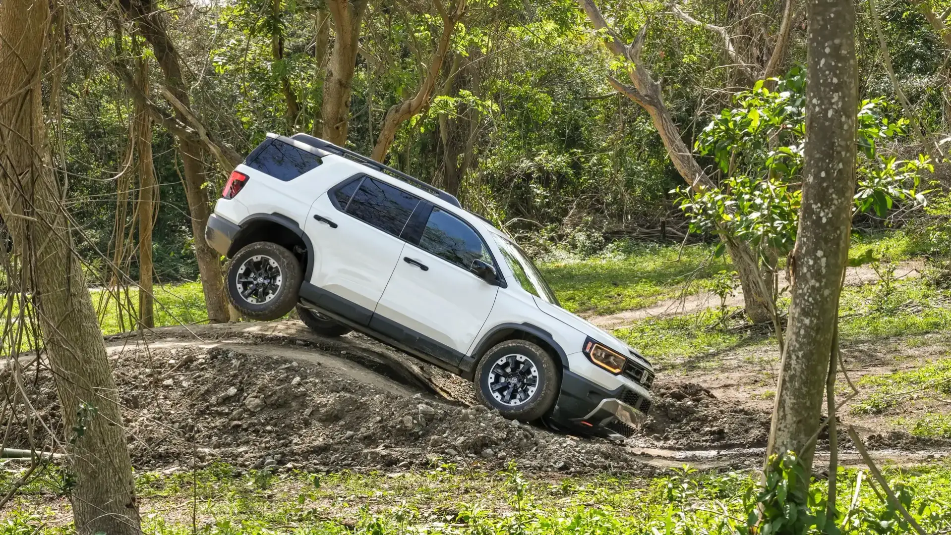 2026 Honda Passport TrailSport Elite off roading on a dirt hill