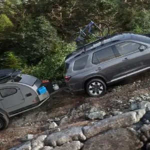 2026 Honda PIlot Elite Modern Steel Metallic towing a camping trailer