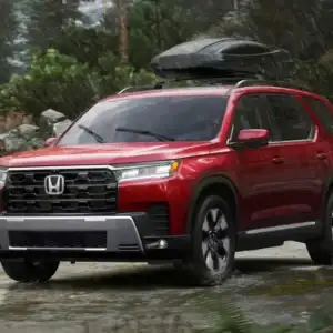 2026 Honda Pilot Elite Radiant Red Metallic II driving in rain
