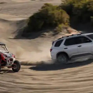 2026 Honda Pilot TrailSport Solar Silver Metallic driving through sand