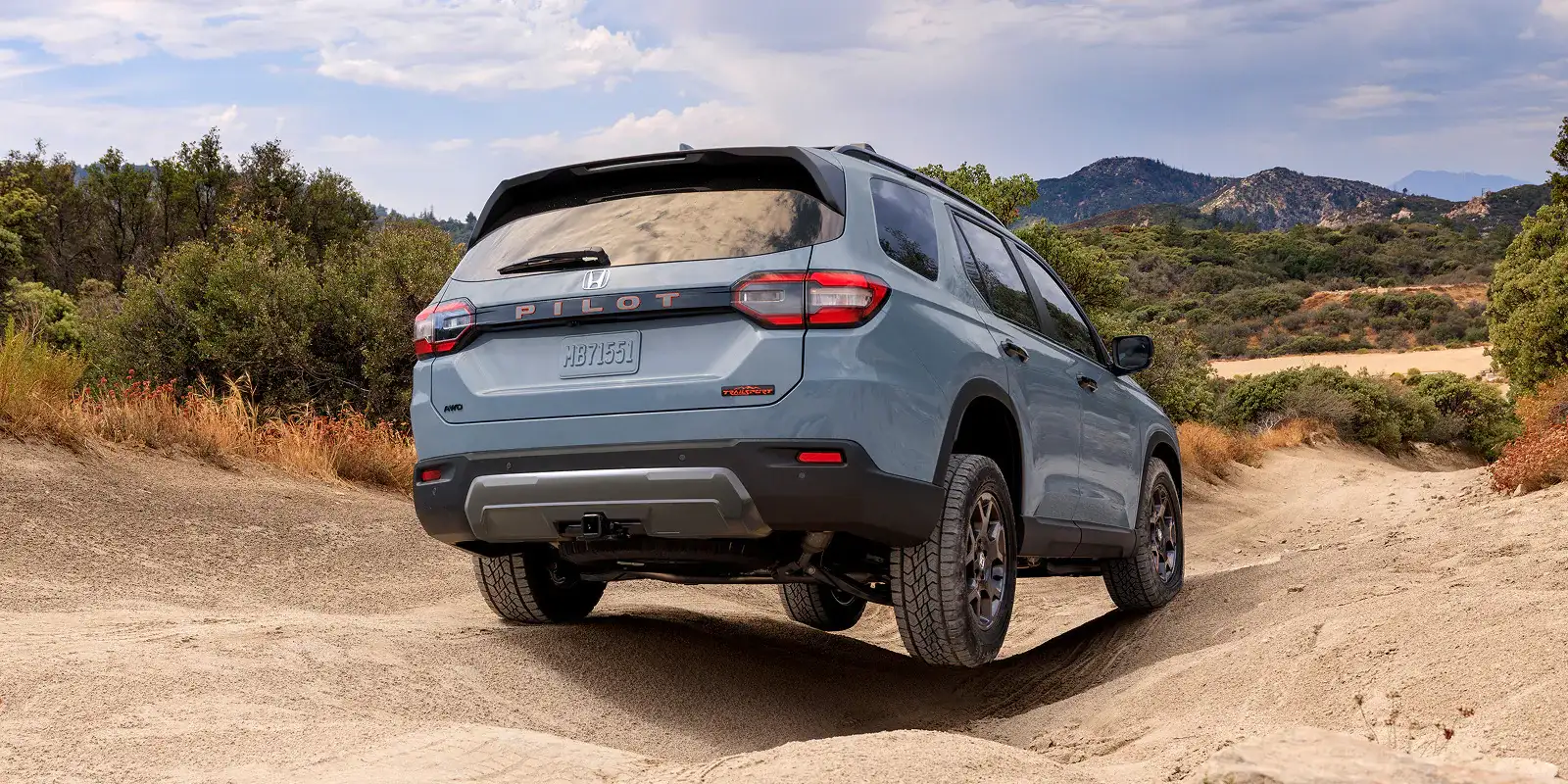 2026 Honda Pilot Trailsport Sonic Gray Pearl rear view on sand